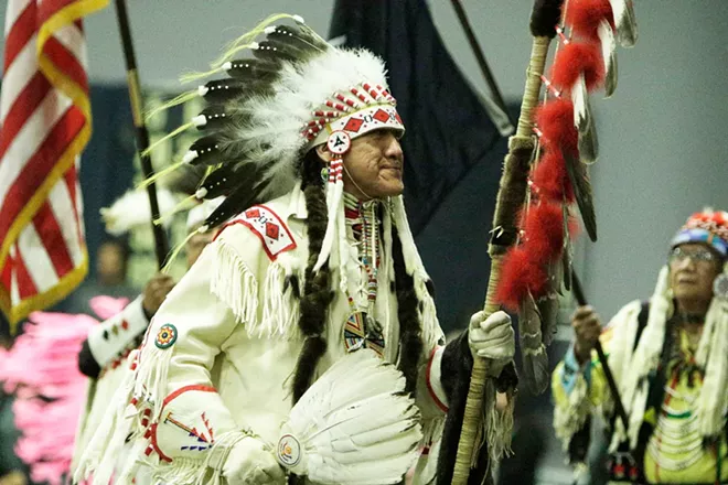 Dave BrownEagle, of the Spokane Tribe and Ho-Chunk Nation, leads the opening procession while carrying an eagle staff. - YOUNG KWAK