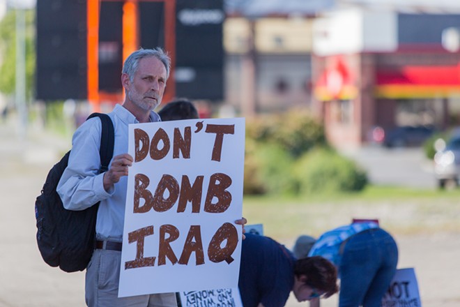 David Brookbank protests against the threat of bombing Iraq. - MATT WEIGAND