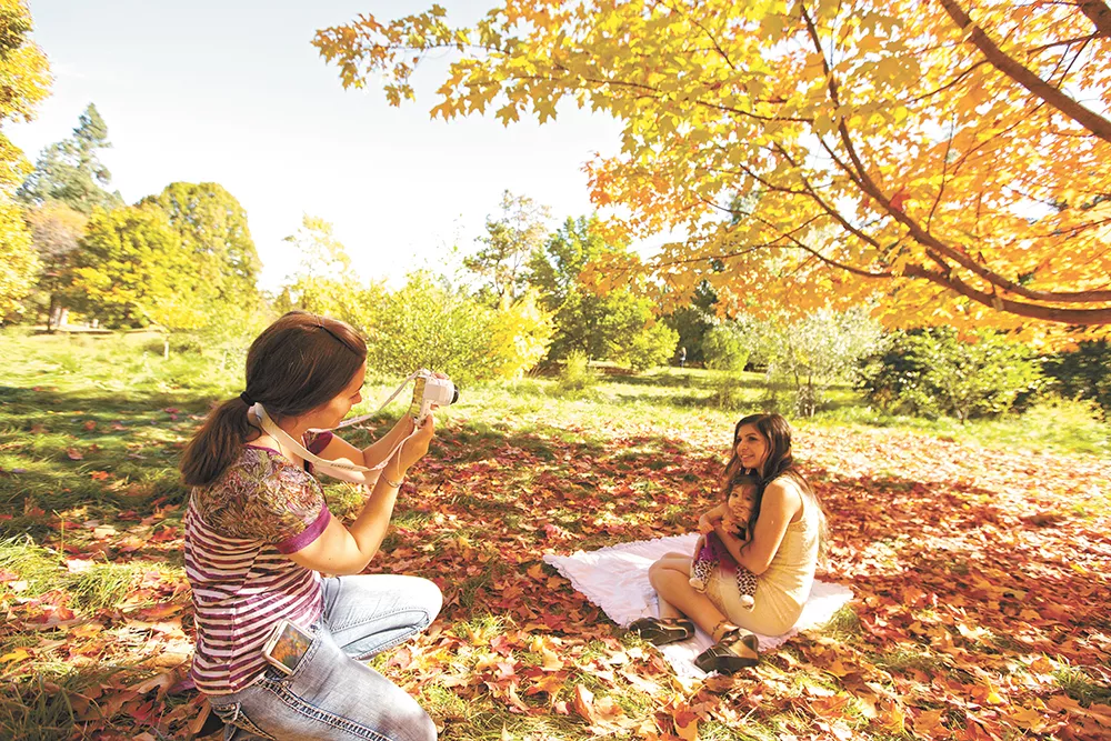 Desiree Azizi, right, and her 1-year-old daughter Talaiya have their photograph taken by friend Cayla Bowers. - YOUNG KWAK