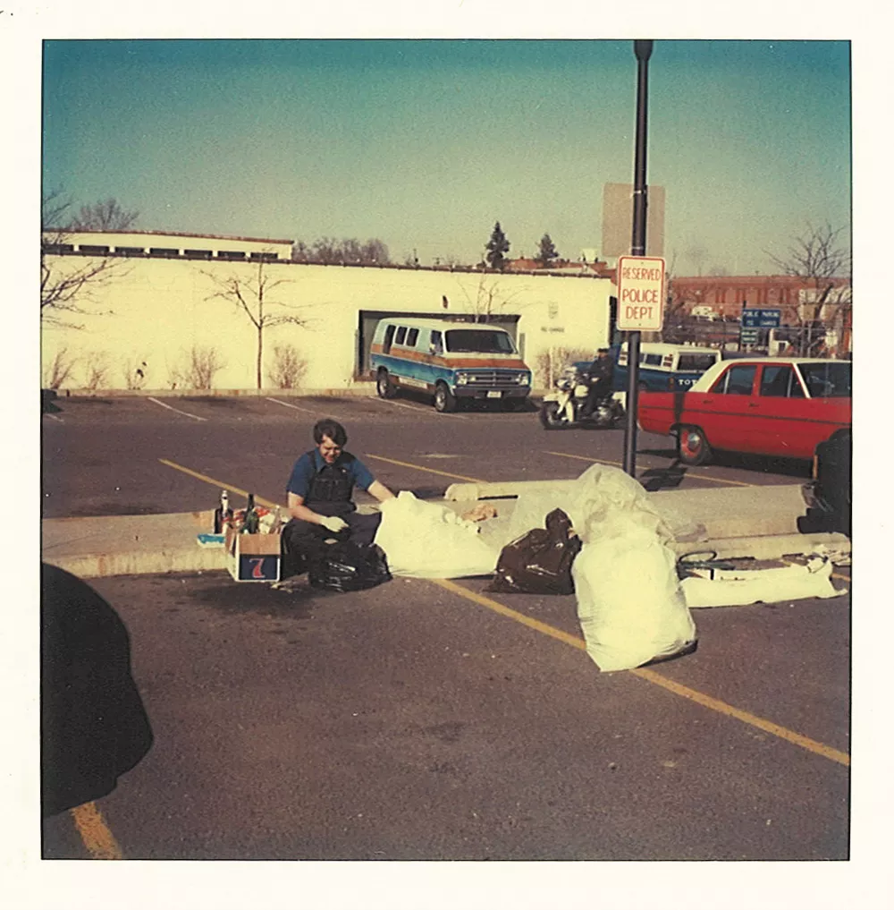 Detective Brian Breen going through the - contents of Linda’s garbage on March 14, 1981 in the parking lot of the public safety building.