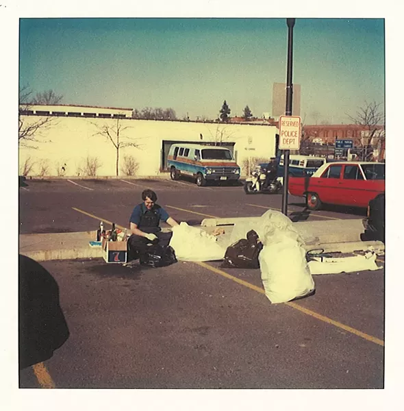 Detective Brian Breen going through the - contents of Linda’s garbage on March 14, 1981 in the parking lot of the public safety building.