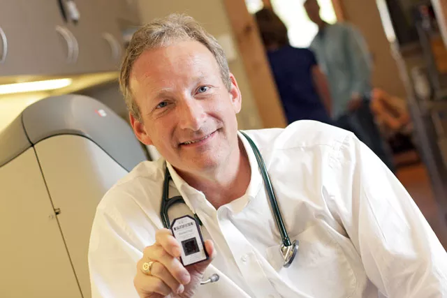 Dr. Stephen Anthony with a gene chip containing the molecular genetic profile of an individual used to guide cancer treatment. - YOUNG KWAK