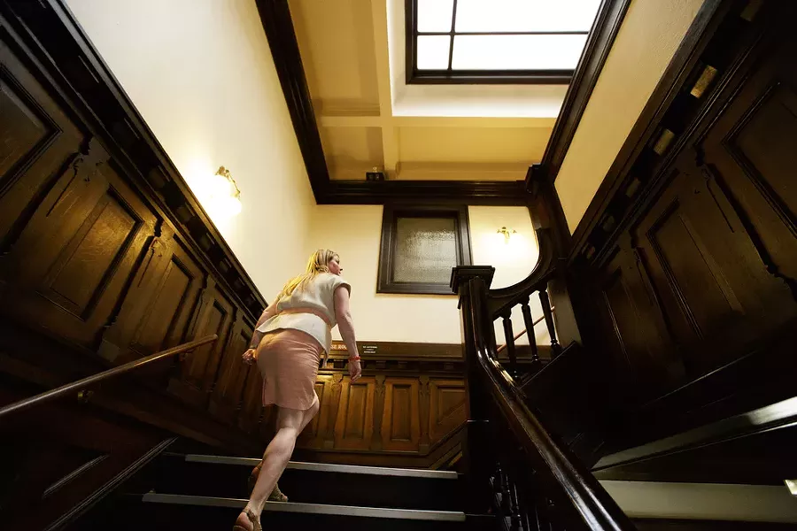 Events Manager Kimberley Scott walks up a flight of stairs at the Riverside Event Center. - YOUNG KWAK