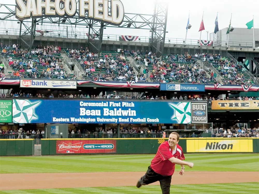 EWU football coach Beau Baldwin, throwing out the first pitch at the Mariners game last Saturday. - BEN VANHOUTEN