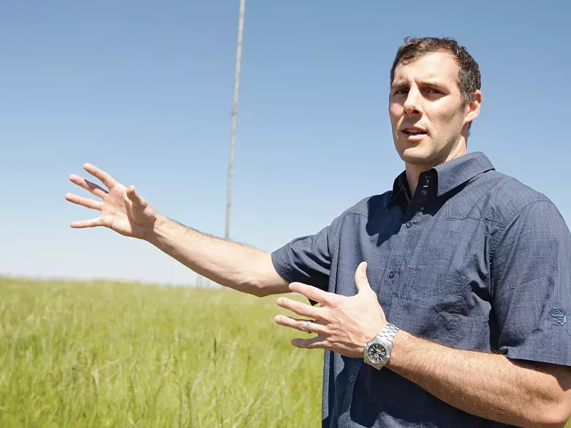 First Wind's Ben Fairbanks standing on a future wind farm. - YOUNG KWAK