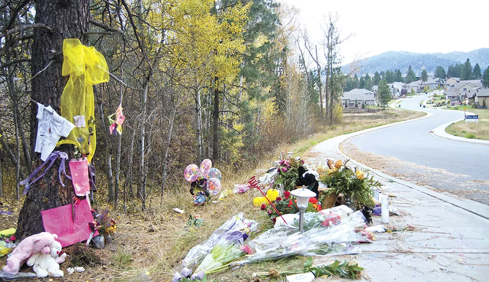 Flowers, photos and ribbons adorn the curve of South Bates Road where Josie Freier and McKenzie Mott died. - JACOB JONES