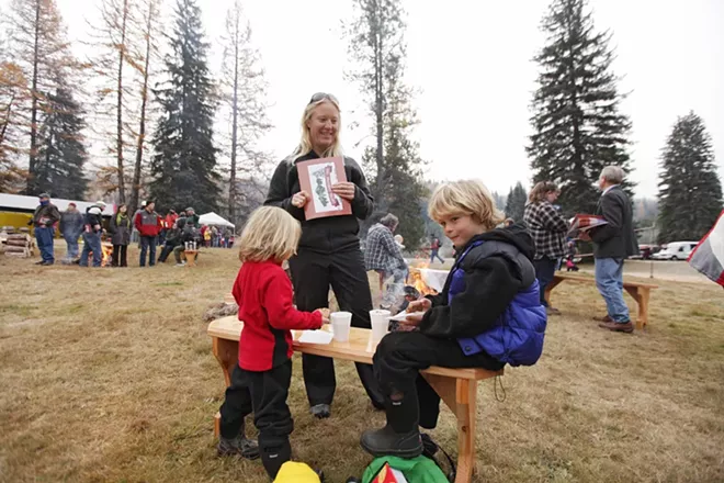 Four-year-old Maggie McClure, left, and her brother Connor, 7, eat cookies and drink hot chocolate, as their mother Erin watches. - YOUNG KWAK