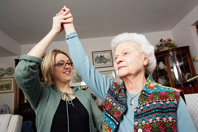 Gentiva Health Services neurorehabilitation director Kristin Rue, PT, NCS, does a stretching exercise with her 89-year-old grandmother Doris Swanson in Spokane. - YOUNG KWAK