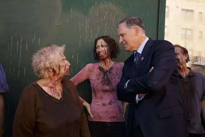 Governor Jay Inslee, right, speaks with zombie extra Susan Cleveland, left, as Brie Edwards looks on. - YOUNG KWAK