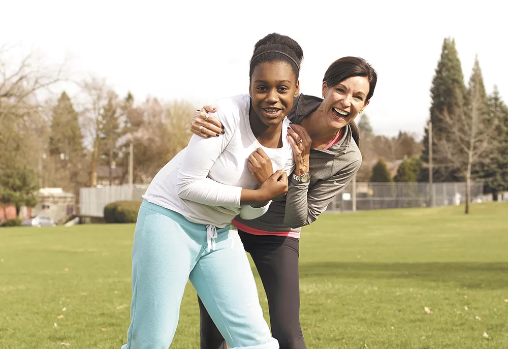 Grant Elementary sixth grader Jada Richardson and mentor Sue Eymann loosen up before a 5k run. - YOUNG KWAK