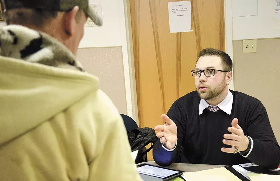 In-person assister Matthew Olson helps a homeless man enroll in Obamacare. - JACOB JONES