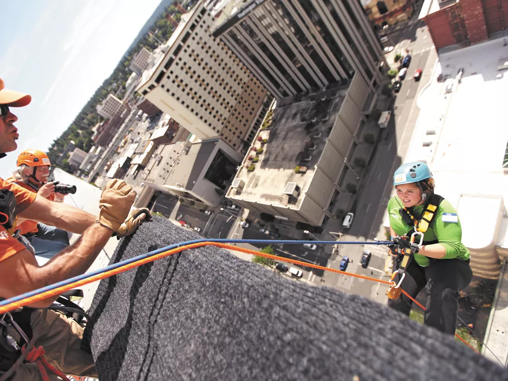 Inlander staffer Jordy Byrd gives a terrified smile as she dangles from the Bank of America building. - YOUNG KWAK