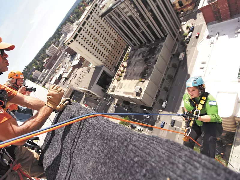 Inlander staffer Jordy Byrd gives a terrified smile as she dangles from the Bank of America building. - YOUNG KWAK