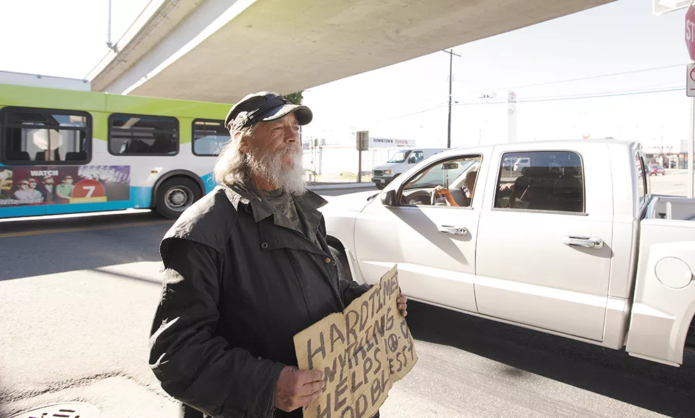 Jeffery Mitchell Reid panhandles at the intersection of Jefferson and the I-90 on-ramp in Spokane.| - YOUNG KWAK
