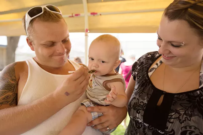 John Inglis, left, feeds his 10 month old son John Jr., haggis as his wife Amanda looks on. - YOUNG KWAK