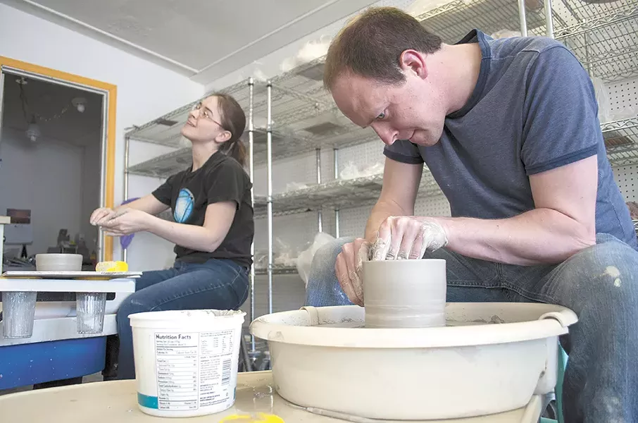 Karen Mannino and Nick Lowe throw clay on a pottery wheel at Urban Art Co-op. - SARAH WURTZ