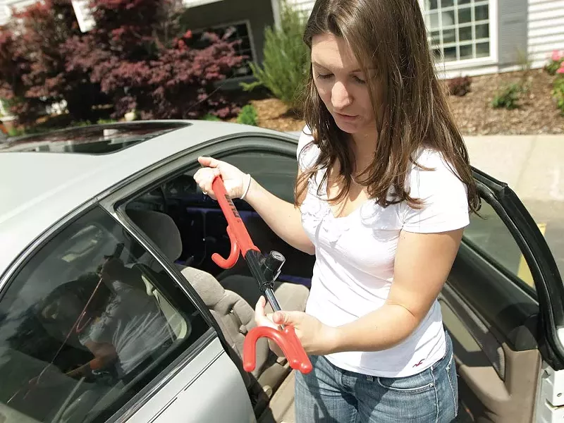 Karissa Mielke shows off 'The Club,' which she now uses after her car was stolen - twice. - YOUNG KWAK