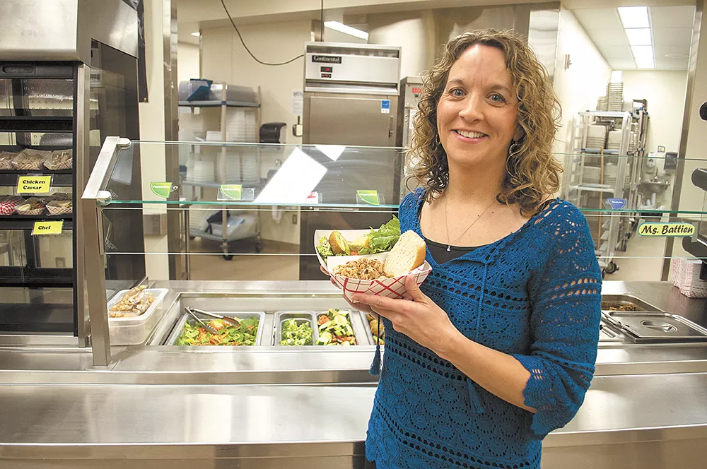 Laura Martin (left), the wellness coordinator at Cheney Middle School, shows off a healthy school lunch. - SARAH WURTZ