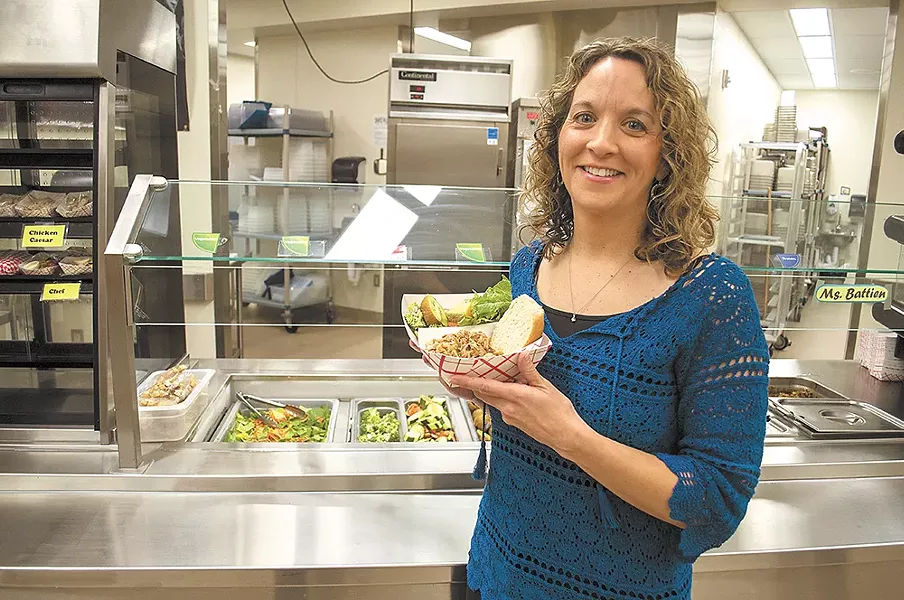 Laura Martin (left), the wellness coordinator at Cheney Middle School, shows off a healthy school lunch. - SARAH WURTZ