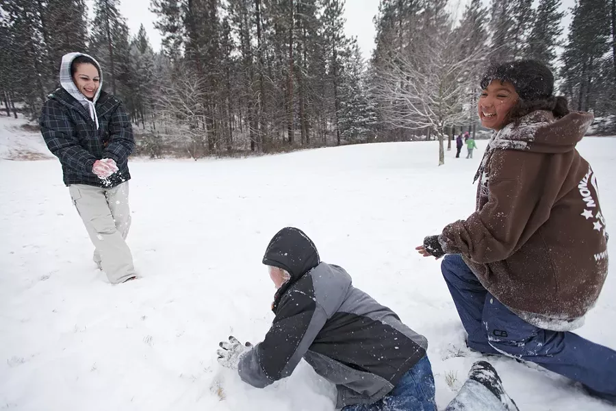 (Left to right) Josie Leyba, Samuel Bakken and Nessa Trevino have a snowball fight at Underhill Park. - YOUNG KWAK