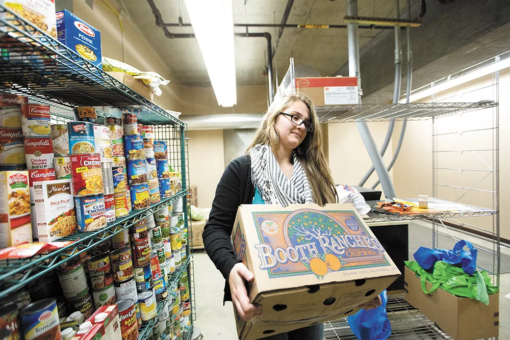 Lewis and Clark High School senior Danielle Aranda works at the school's Tiger Food Pantry for course credit. - YOUNG KWAK