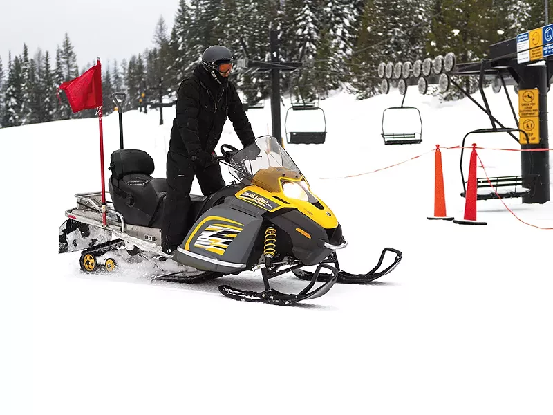 Lift Supervisor Stephen Jones snowmobiles to Lift No.4 for an inspection.