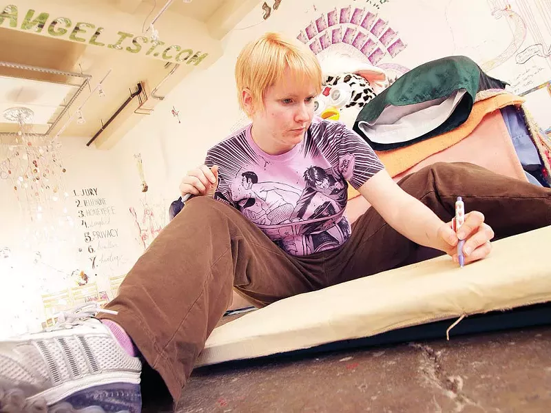 Marcia Dukes preps a painting on an ironing board during MONTH - YOUNG KWAK