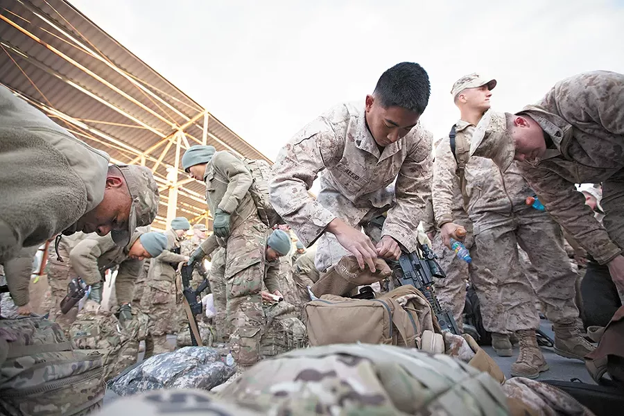 Marine Cpl. Arnold Alejo goes through his luggage, making sure he's ready for his trip home. - YOUNG KWAK