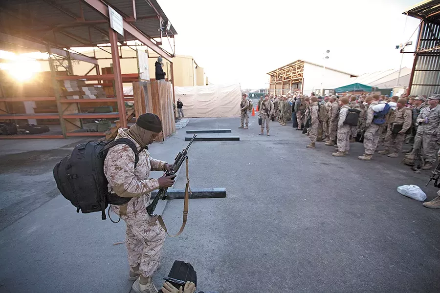 Marine Sgt. Lloyd Beckford checks his rifle during a customs briefing, the first step to going home from a combat deployment in Afghanistan. - YOUNG KWAK