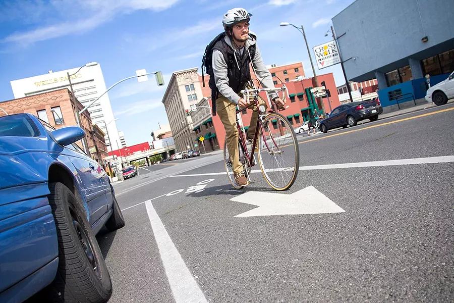 Mark Wilkins uses the bike lane on Howard and Second Avenue in downtown Spokane. - JENNIFER DEBARROS