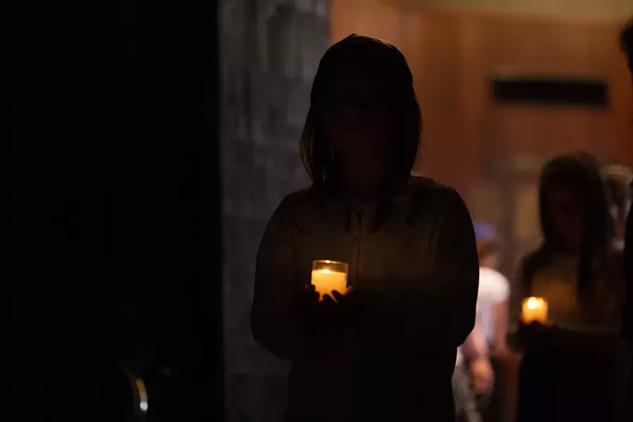 Members of the Spokane Jewish Youth carry candles. - YOUNG KWAK