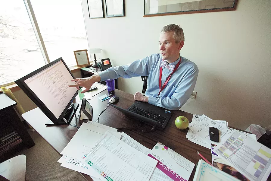Mike Nelson, the Coeur d'Alene School District's director of curriculum and assessment, points to Schoolnet, an educational software system that still hasn't delivered on its big promises. - YOUNG KWAK