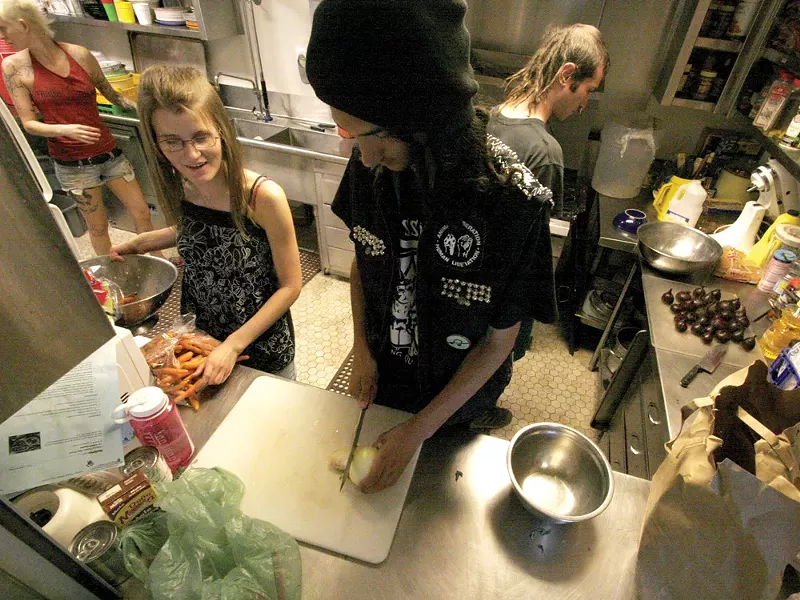 Nathan Kelm (center) and members of Spokane Food Not Bombs get creative with what they have. - RHEA BEUMER