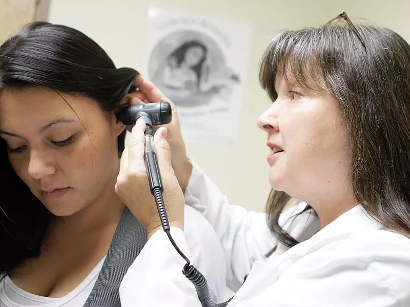 Nurse Vinetta MacPherson (left) demonstrates a medical exam on fellow employee Dezerae Hays at NATIVE Health of Spokane. - YOUNG KWAK