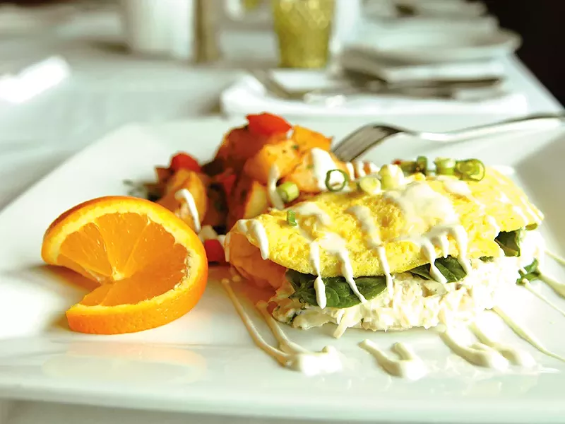 One of Clover\'s specialty brunch items: a crab and artichoke omelet with rosemary breakfast potatoes. - ELLA HERHILAN
