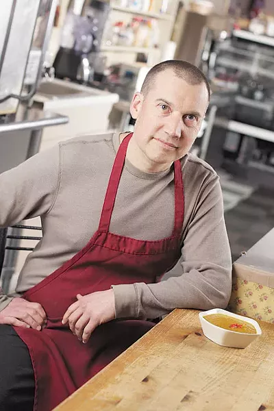 One World Spokane Chef Andrew Larson with a bowl of roasted winter squash soup — made with ingredients grown on-site. - YOUNG KWAK