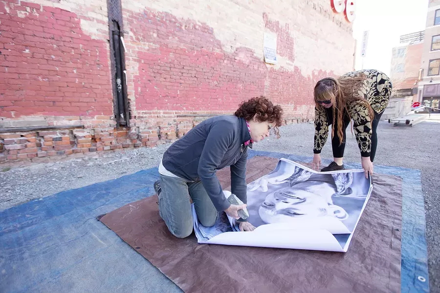 Organizers Susan Jane Hall, left, and Adrienne Belnap hold a photograph of Curtis. - YOUNG KWAK