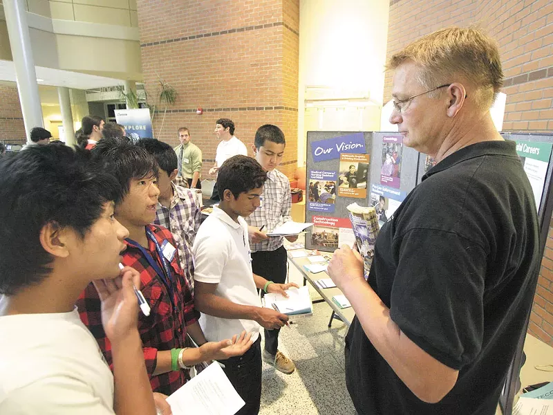 Pranesh Rai, second from left, speaks to Scott Oakshott of the Spokane Skills Center - YOUNG KWAK PHOTO