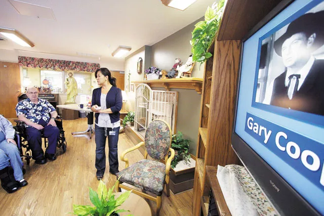 Recreational specialist Cindy Penna runs through a Memory Programs DVD with residents at Spokanes Providence St. Joseph Care Center. - YOUNG KWAK