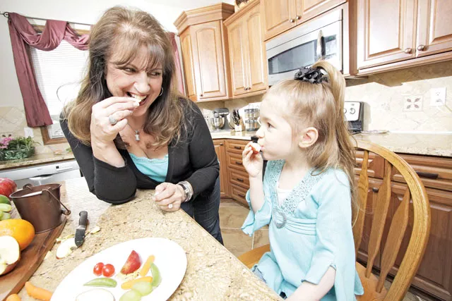 Resa Hunt shares a snack plate with her 4-year-old granddaughter Charesa in Spokane Valley. - YOUNG KWAK