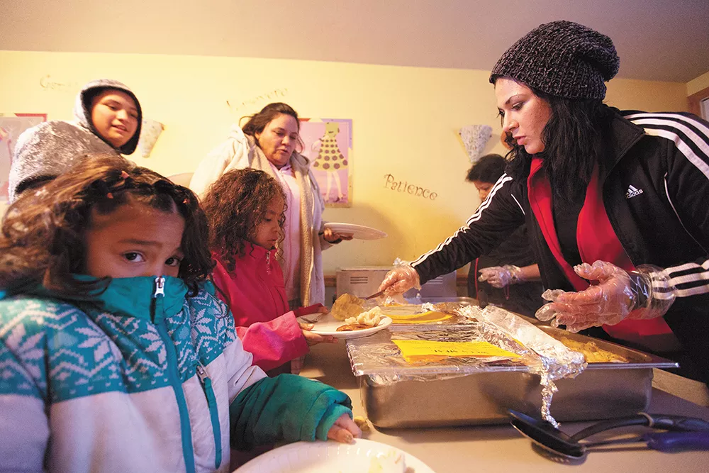 Resident Brianna Arena, right, serves dinner to fellow residents at the Union Gospel Mission shelter. - YOUNG KWAK