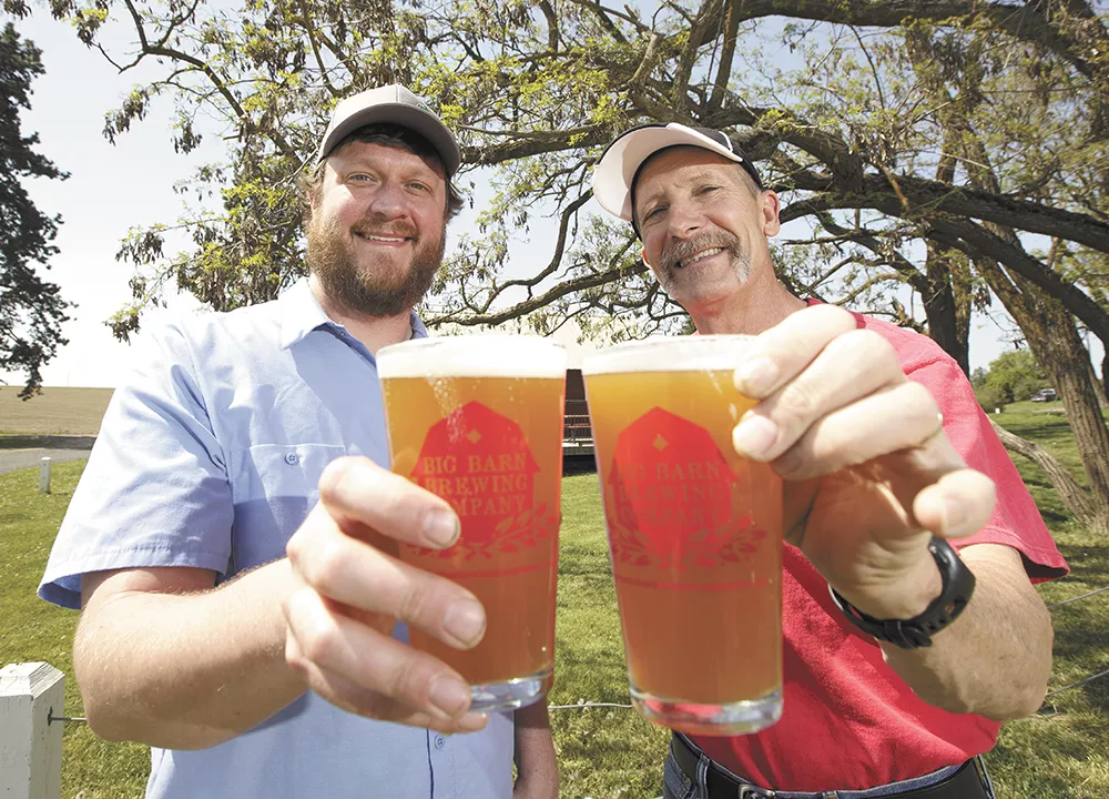 River City Brewing's head brewer, Moose Sanders, left, and Big Barn Brewing Company co-owner Craig Deitz with pints of their Spokane Craft Beer Week