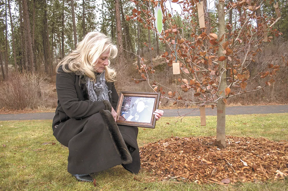 Sandra Carr with a photo of her son, Mark Overland, at his tree-planting memorial service at Mirabeau Park. - SARAH WURTZ