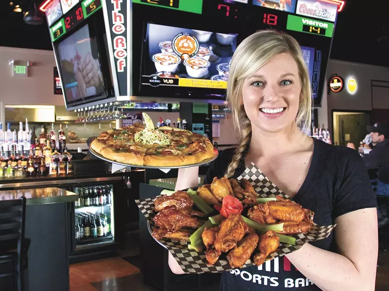 Server Jen Has shows off The Ref’s wings and pizza. - JEFF FERGUSON