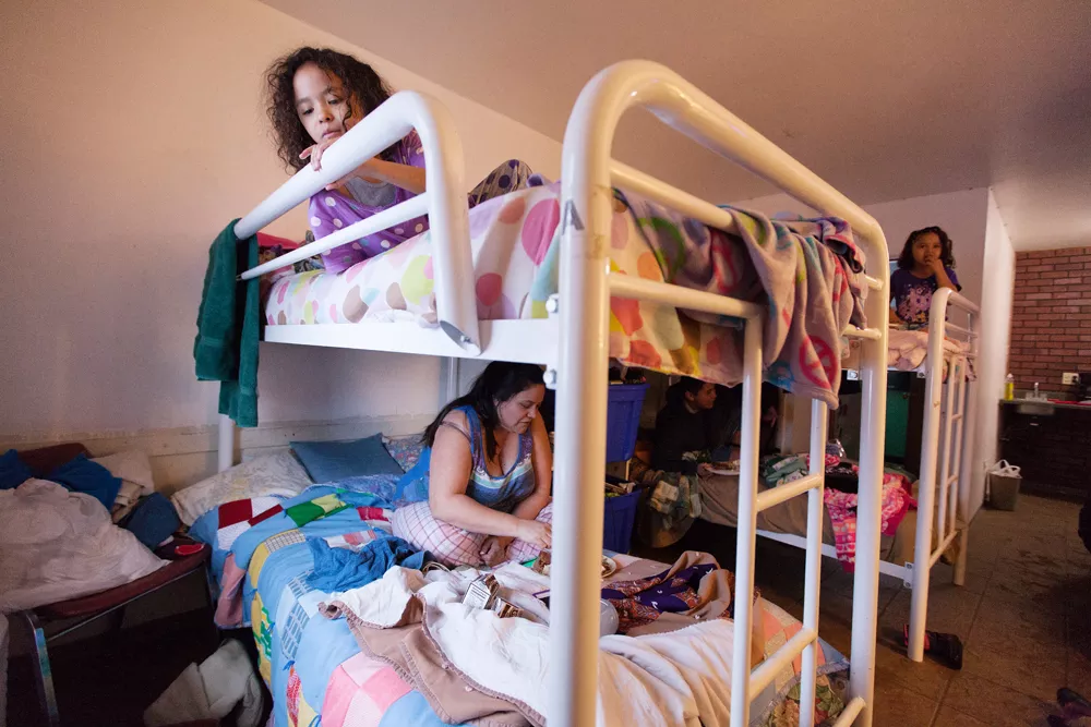 Seven-year-old Savannah Owens, top, and her mother, Elizabeth Vasquez, eat in their room at the Union Gospel Mission Crisis Shelter for Women and Children. - YOUNG KWAK