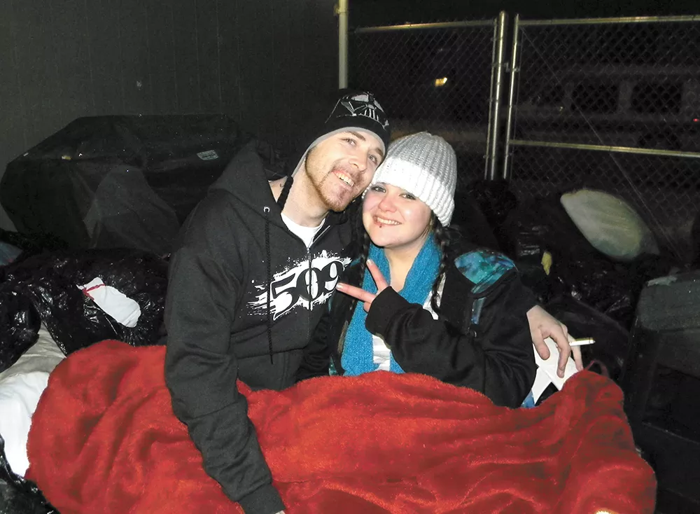 Shayla Bengtson and a man who identified himself only as Filthy White Boy wait for New Year's Eve fireworks. - JAKE THOMAS