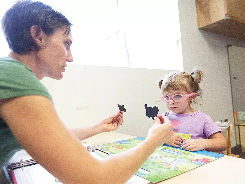 Speech Therapist Jen Wells leads a word exercise with 2-year-old student Abygail at Spokane Guilds\' School. - YOUNG KWAK