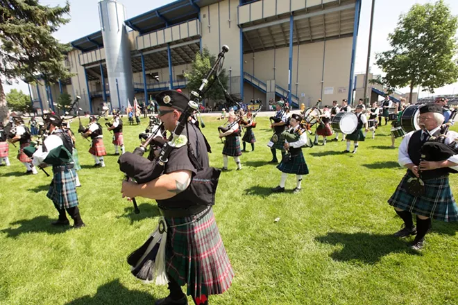Spokane County Firefighters Pipes & Drums member Nate Brown, front, performs during the opening ceremonies. - YOUNG KWAK