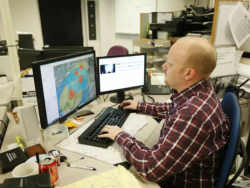 Spokane Police Department Crime Analyst Tom Michaud looks at a crime hot spot map. - YOUNG KWAK