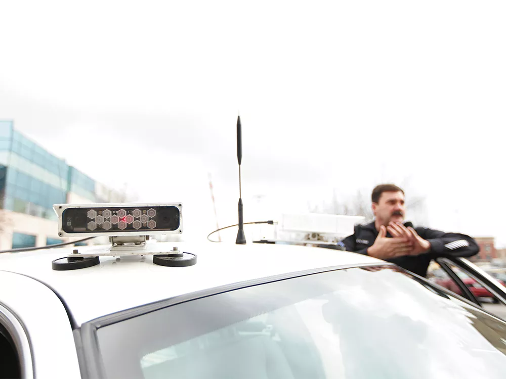 Spokane Police Officer Dan Cole has driven one of the department\'s two license-plate-scanner-equipped vehicles for about a year. - YOUNG KWAK